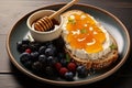 Plate displays bread, cream cheese, fruits artful flat lay adorned with golden honey