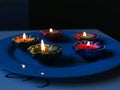 A close-up view of diyas placed on a plate to celebrate dhanteras