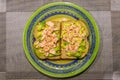 Plate with a double sandwich containing raw avocado and fried salmon only