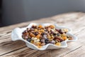 Plate of dried fruits on wooden table, Mix of nuts and berries: raisins, hazelnut, cashews, almonds, cranberries, dried Royalty Free Stock Photo