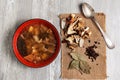 Plate with dried porcini mushroom soup and soup ingredients Royalty Free Stock Photo