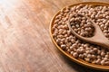 Plate with dry chickpeas and spoon on table Royalty Free Stock Photo