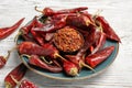 Plate with dry chili peppers and powder Royalty Free Stock Photo