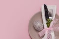 Plate with eating utensils on a napkin and an egg on a pastel pink background copy space Easter menu concept Royalty Free Stock Photo