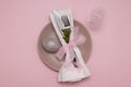 Plate with eating utensils on a napkin and an egg on a pastel pink background Easter menu concept Royalty Free Stock Photo