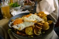Plate of egg and potato chips served in the restaurant with a glass of beer on the background Royalty Free Stock Photo