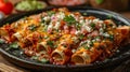 A plate of enchiladas with cheese and cilantro. Royalty Free Stock Photo