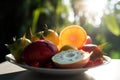 Plate of exotic tropical fruits including Litchi, pitaya, Durian, pineapple, mango, coconut, Guajava, Passion fruit, Passiflora,