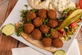 Falafel with Hummus, sliced Tomatoes, Cucumbers, and a mix of diced vegetables Royalty Free Stock Photo
