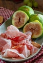 Plate of figs and raw ham, a typical Italian appetizer Royalty Free Stock Photo