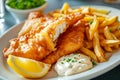 plate of fish and chips, a British fast food with battered and fried fish fillets and thick-cut fries