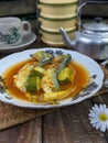 a plate of fish cookes in spicy sour sauce called asam pedas