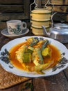 a plate of fish cookes in spicy sour sauce called asam pedas