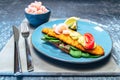 Plate of fish fillet with fresh prawns, lemons and vegetables