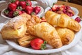 plate of flaky puff pastries and turnovers, filled with classic fillings such as cream cheese and strawberries Royalty Free Stock Photo