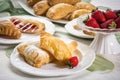 plate of flaky puff pastries and turnovers, filled with classic fillings such as cream cheese and strawberries Royalty Free Stock Photo