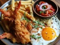 a plate of food with a fried egg and fries Royalty Free Stock Photo