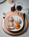 a plate with food on it next to a glass of wine Royalty Free Stock Photo