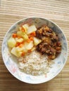 Plate of food with rice, beans and potato