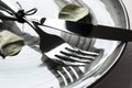 Plate with fork and knife on table, closeup Royalty Free Stock Photo