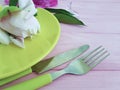 Plate, fork, peony flower knife arrangement design equipment wedding catering equipment design on a pink wooden background Royalty Free Stock Photo