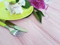 Plate, fork, peony flower knife design equipment wedding catering equipment design on a pink wooden background Royalty Free Stock Photo