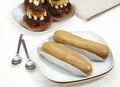 PLATE WITH FRENCH CAKES CALLED CHOCOLATE RELIGIEUSE AND COFFE ECLAIR