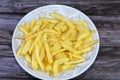 A plate of French fries potatoes fried in boiling hot oil in a deep fryer at home. French fries, Junk food concept, home made deep Royalty Free Stock Photo