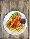 Plate with french fries and tasty hot dog Royalty Free Stock Photo