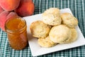 Plate of fresh biscuits with peach jam Royalty Free Stock Photo