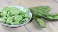 A plate of fresh broad beans on the wooden table in the kitchen Royalty Free Stock Photo