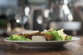 Plate with fresh caesar salad with chicken on old wooden table Royalty Free Stock Photo