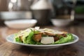 Plate with fresh caesar salad with chicken on old wooden table Royalty Free Stock Photo