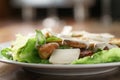 Plate with fresh caesar salad with chicken on old wooden table Royalty Free Stock Photo