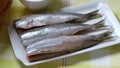 Plate with fresh Dutch raw herring close up