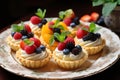 A plate of fresh fruit tartlets with pastry cream Royalty Free Stock Photo