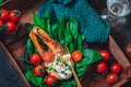 A plate with fresh green raw spinach and fried wild salmon, tomatoes and cream cheese sauce Royalty Free Stock Photo