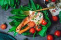 A plate with fresh green raw spinach and fried wild salmon, tomatoes and cream cheese sauce Royalty Free Stock Photo