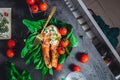 A plate with fresh green raw spinach and fried wild salmon, tomatoes and cream cheese sauce Royalty Free Stock Photo