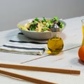 Plate of fresh Mediterranean salad with olive oil served with orange juice on a white wooden table Royalty Free Stock Photo