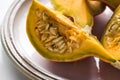 Plate with fresh ripe pumpkin quarters with seeds.