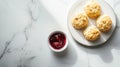A plate of freshly baked biscuits served with a small bowl of jam Royalty Free Stock Photo