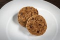 Plate of freshly baked chocolate chip cookies. Wooden background, selective focus Royalty Free Stock Photo