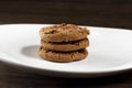 Plate of freshly baked chocolate chip cookies. Wooden background, selective focus Royalty Free Stock Photo