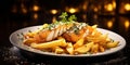 A plate of freshly grilled fish and chips with seasoning and garnish Royalty Free Stock Photo