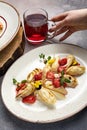 Tasty pancakes with filling and strawberries served on a plate with a glass of tea Royalty Free Stock Photo