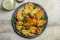 Plate with Fried in a batter Zucchini Flowers stuffed with ricotta cheese and parsley. Royalty Free Stock Photo