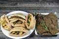 A plate of fried beef liver slices and fried shrimps, beef brain, beef liver slices deep fried in oil and served with parsley in a