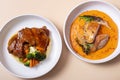 Plate with fried chicken and carrot-potato puree and plate of beef ribs in barbecue sauce with vegetables Royalty Free Stock Photo