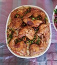 A plate of fried chicken with nuts and rice